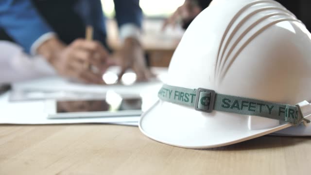 Dolly shot Safety helmet and Engineer or Architect working on Background, Safety first Concept